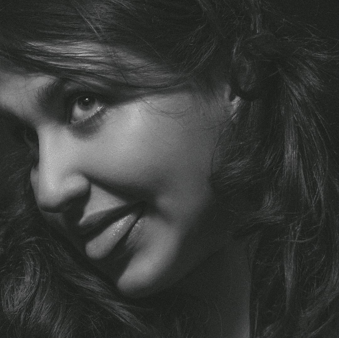 Close portrait of a smiling woman with elegant makeup at a gala
