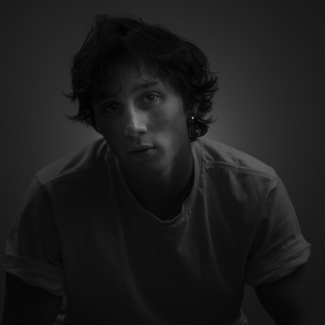 Black and white portrait of a pensive man looking at the camera