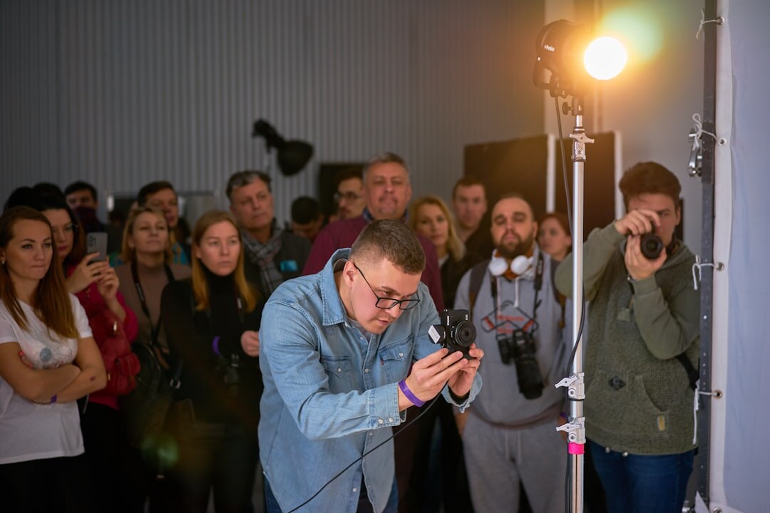 Rows of camera flashes and photographers at a red carpet premiere