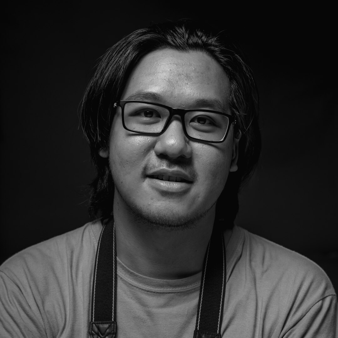Studio portrait of a man with short beard and glasses